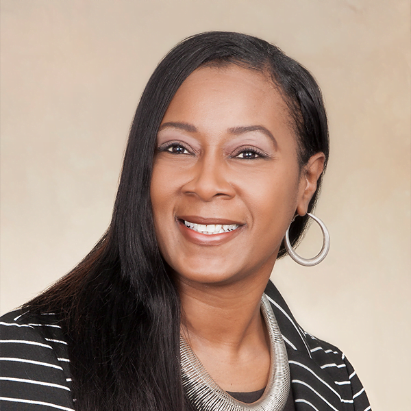 A picture of Jeanette, a woman with brown hair and eyes smiling at the camera