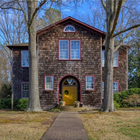A large two story home with shaker shingles
