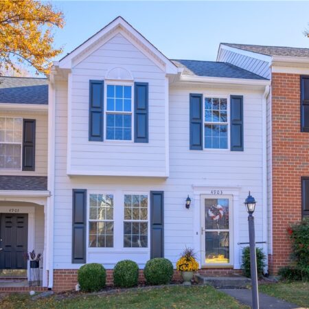 A white townhome with black shutters