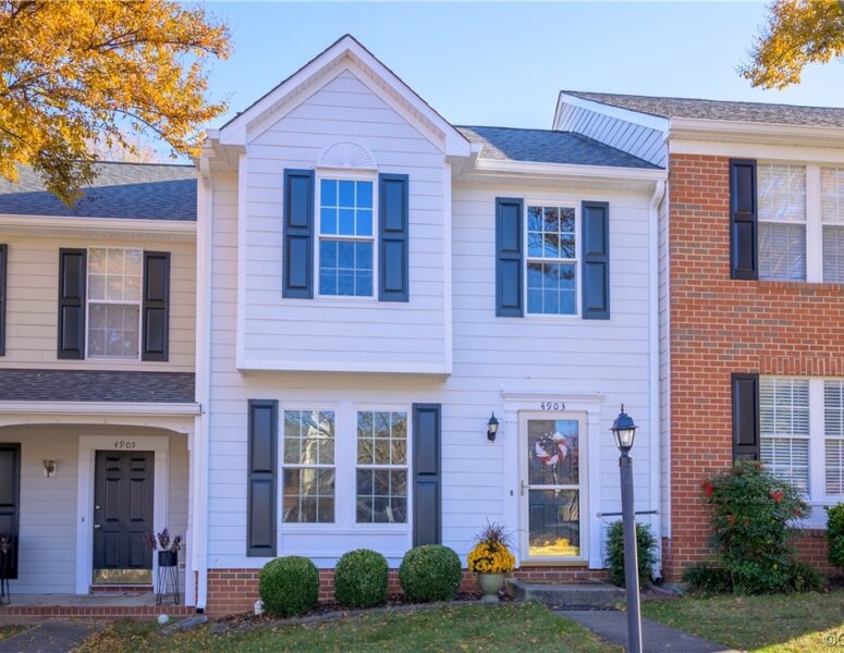 A white townhome with black shutters