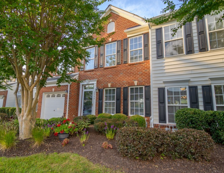 The front of an attached townhome with red brick