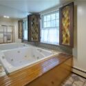 A bathroom with large jacuzzi tub